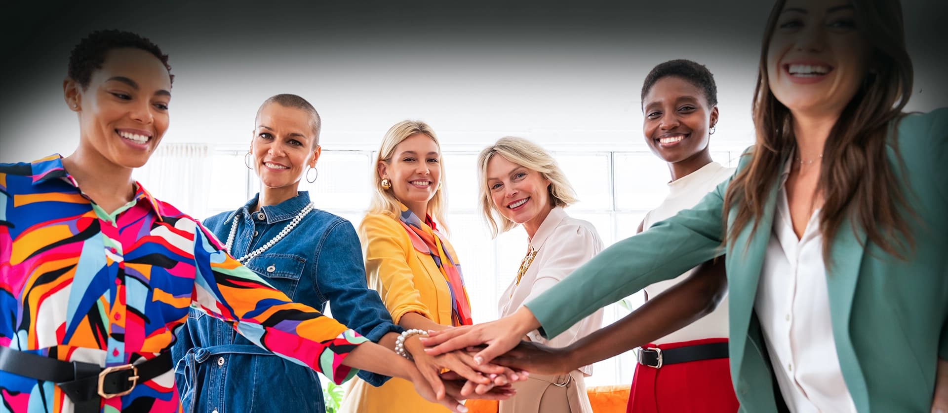 Women of the Sister's Keeper Foundation community, hands together